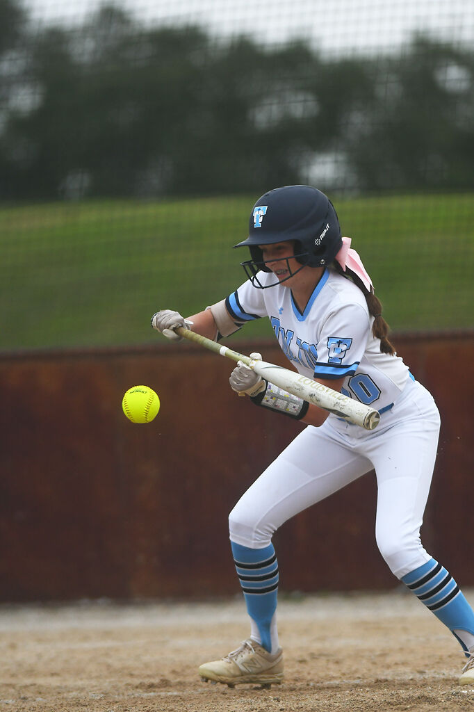 Tolton player Olivia Mobley bunts the ball during the game between Hickman High School